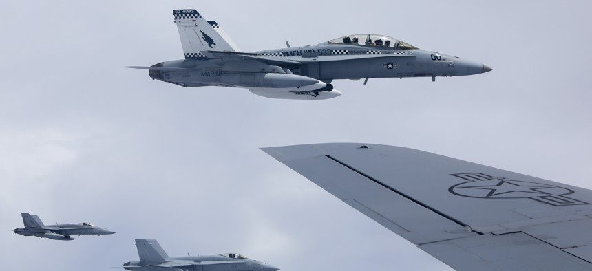 U.S. Marine Corps F/A-18 Hornet aircraft with Marine All Weather Fighter Attack Squadron (VMFA(AW)) 533 fly in formation with an Air National Guard KC-130 Stratotanker aircraft with the 506th Expeditionary Air Refueling Squadron, over the Pacific Ocean, May 28, 2022. 