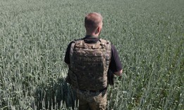 A Ukrainian serviceman attends at wheat field on the front line near the city of Soledar, Donetsk region, on June 10, 2022.