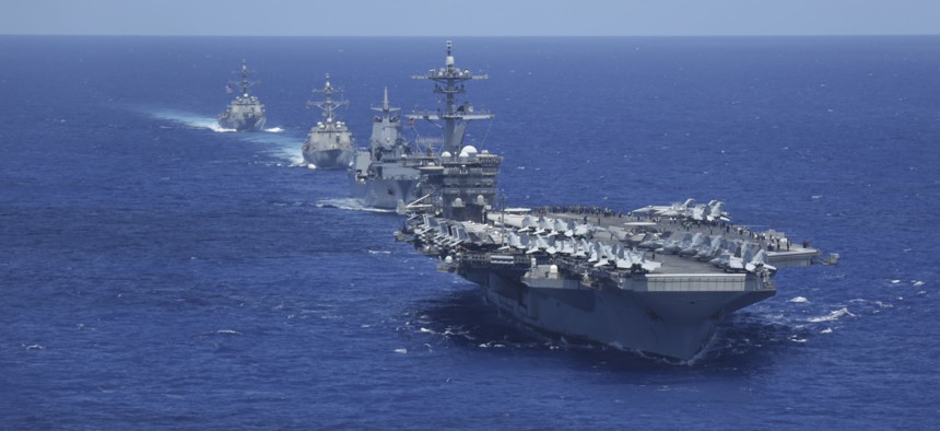 USS Abraham Lincoln (CVN 72), Royal Australian Navy auxiliary oiler replenishment ship HMAS Supply (AO 195), and the Arleigh Burke-class guided-missile destroyers USS Gridley (DDG 101) and USS Spruance (DDG 111) sail in formation in the Pacific Ocean  on June 23, 2022.