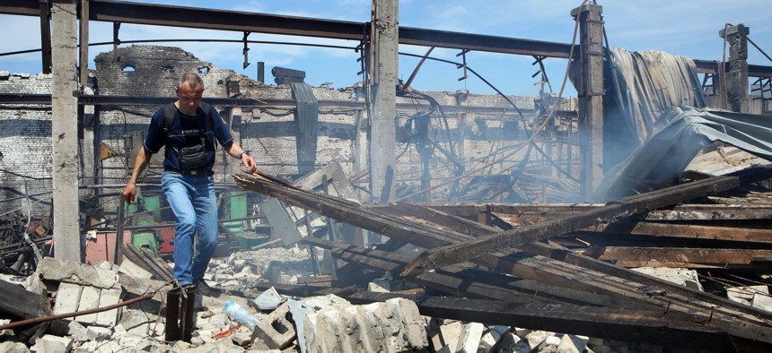 A man walks on June 29, 2022, in the wreckage of the Mashhidropryvid plant in Kharkiv, Ukraine, damaged by a Russian rocket attack. 