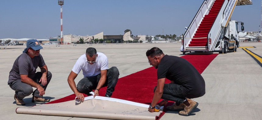 Employees at Israel's Ben Gurion Airport in Lod near Tel Aviv lay the red carpet on July 12, 2022, ahead of US President Joe Biden's visit.