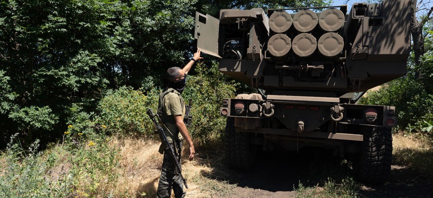 uzia, the commander of the unit, shows the rockets on HIMARS vehicle in Eastern Ukraine on July 1, 2022.