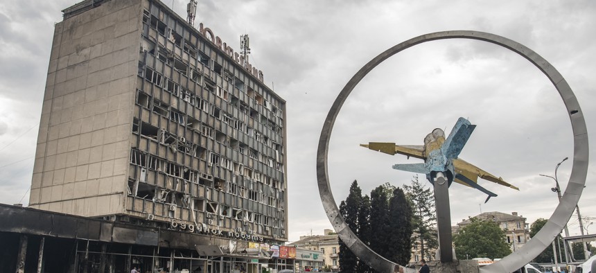 A damaged monument in honor of the Ukrainian Air Force with a Soviet MiG-21 fighter jet and civil infrastructure building at the site of a Russian cruise missile strike in Vinnytsia, Ukraine July 15, 2022
