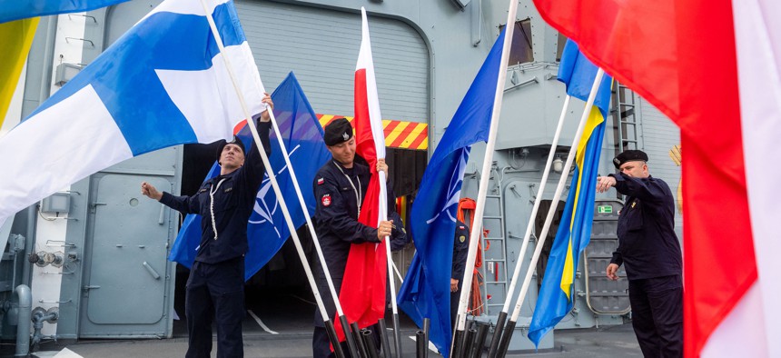 Polish, Swedish, Finnish, and NATO flags are set up prior to a signing ceremony on board the Polish Navy frigate ORP Kosciuszko in Gdynia on July 22, 2022. 