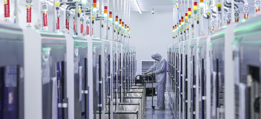 An employee works on a production line of LED epitaxial wafer in a factory of Jiangxi Zhaochi Semiconductor Co Ltd on January 26, 2022 in Nanchang, Jiangxi Province of China. 