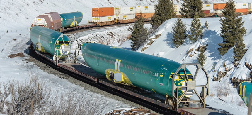 Boeing 737 Max 8 fuselages manufactured by Spirit AeroSystems in Wichita, Kansas, are transported on a BSNF train heading west over the Bozeman Pass in March 2019. 