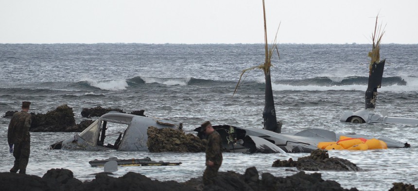 The wreckage of a U.S. Marine MV-22 Osprey tilt-rotor aircraft is seen as the tide recedes on the coast of Okinawa, Japan, on December 14, 2016.