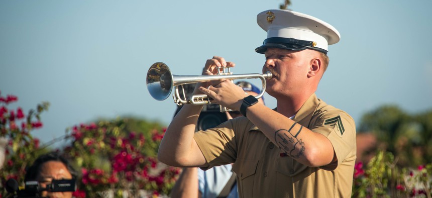 U.S. Marine Corps Cpl. Ryan Worthington, a brass quartet trumpet player for the 1st Marine Division Band, performs Taps during the anniversary of the Battle of Guadalcanal at the Guadalcanal American Memorial in the Solomon Islands, Aug. 7, 2022.