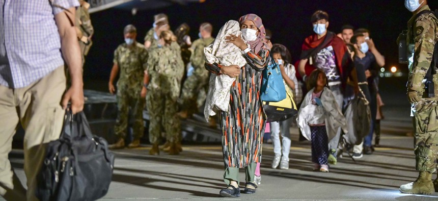 Afghan evacuees disembark a U.S. Air Force C-17 Globemaster III at Naval Air Station Sigonella, Aug. 22, 2021. 