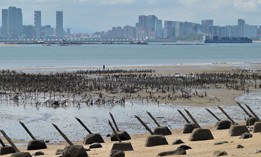 The Xiamen city skyline on the Chinese mainland is seen past anti-landing spikes placed along the coast of Lieyu islet on Taiwan's Kinmen islands, which lie just 3.2 kms (two miles) from the mainland China coast, on August 10, 2022.