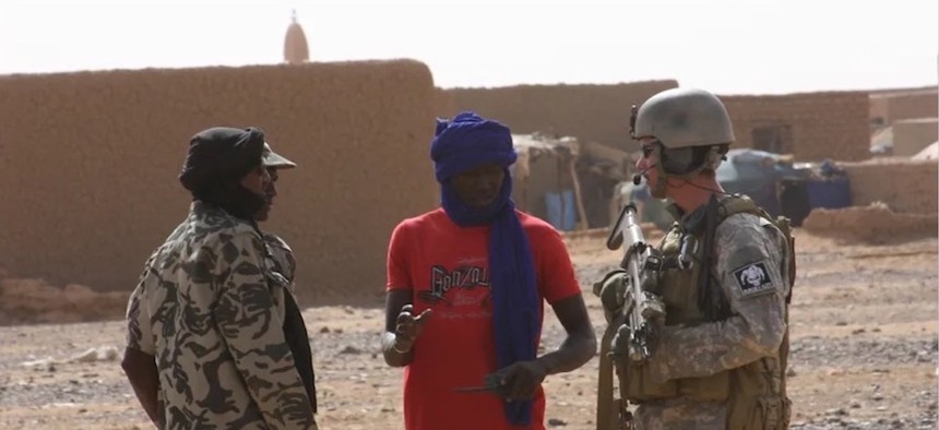 In this 2011 photo, an interpreter in Mali helps the author, right, to advise ethnic Tuareg troops during counterterrorism operations.