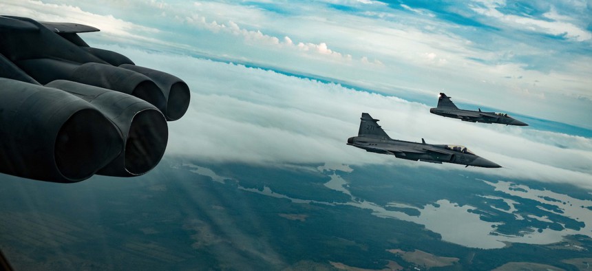 Two Swedish Air Force Saab JAS 39 Gripens escort a U.S. Air Force 23rd Expeditionary Bomb Squadron B-52H Stratofortress over Sweden during a Bomber Task Force mission Aug. 27, 2022.