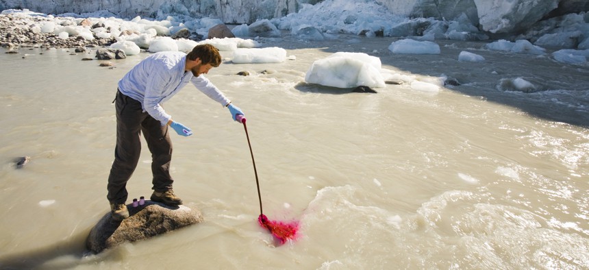 Ian Bartholomew, a scientist, uses dye to measure the speed of the Russell Glacier near Kangerlussuag, Greenland. Like most of the island's glaciers, Russell has speeded up considerably in the last 20 years.