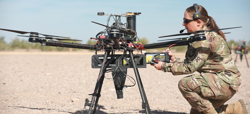 U.S. Army Staff Sgt. Elise Denning, assigned to Artificial Intelligence Integration Center, conducts maintenance on an unmanned aerial system in preparation for Project Convergence at Yuma Proving Ground, Arizona, on October 20, 2021.