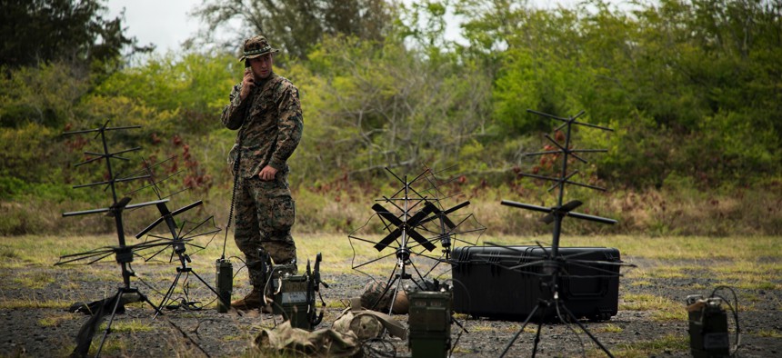 U.S. Marine Corps Cpl. Jonathan Wise, a radio operator with the 3rd Marine Littoral Regiment sets up communication lines at Marine Corps Training Area Bellows, Hawaii, on July 15, 2022, for the biannual Rim of the Pacific exercise.