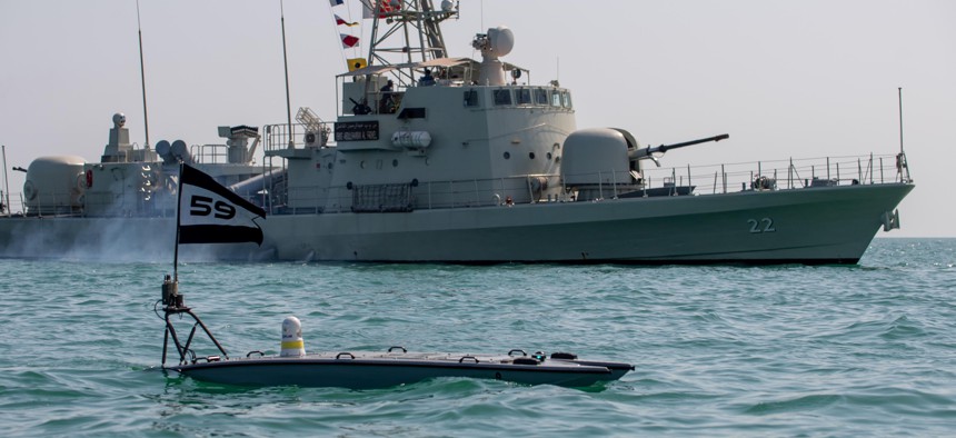 A U.S. MANTAS T-12 unmanned surface vessel, front, operates alongside Royal Bahrain Naval Force fast-attack craft RBNS Abdul Rahman Al-fadel, during exercise New Horizon in the Persian Gulf, Oct. 26, 2021.