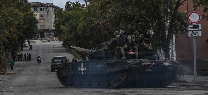 Ukrainian soldiers sit atop a tank in Izyum, Kharkiv Region, eastern Ukraine on September 14, 2022, amid the Russian invasion of Ukraine. 