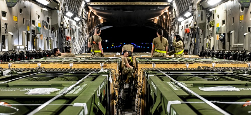 Airmen load Guided Multiple Launch Rocket System munitions onboard a Boeing 767 at Joint Base McGuire-Dix-Lakehurst, N.J., Aug. 13, 2022.