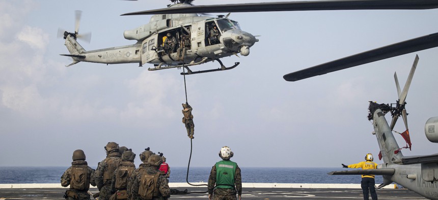 A U.S. Marine with Battalion Landing Team 2/5, 31st Marine Expeditionary Unit, fast ropes during a day and night fast roping exercise aboard USS New Orleans (LPD 18) in the South China Sea, Sept. 15, 2022. 
