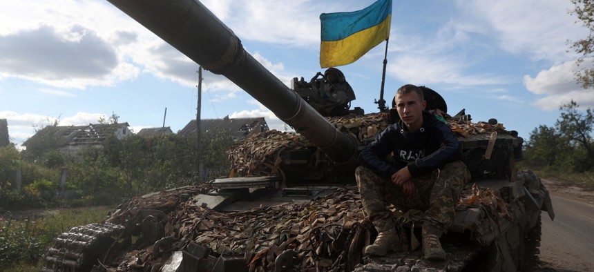 A Ukrainian serviceman sits on a tank on the road near recently released Dolina village, Donetsk region on September 22, 2022.