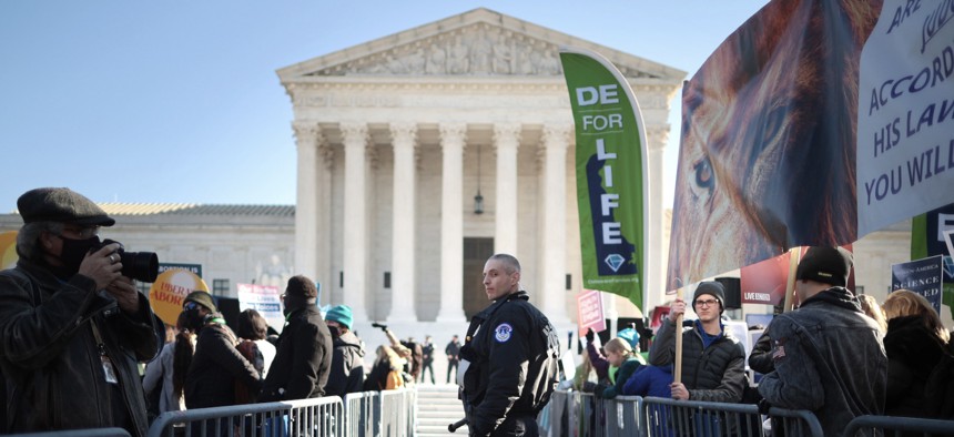 Police use metal barricades to keep protesters, demonstrators and activists apart in front of the U.S. Supreme Court.