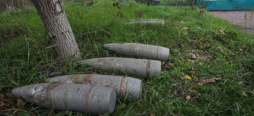 A photograph taken on September 27, 2022, shows artillery shells laid on the ground in the recently liberated village of Vysokopillya, Kherson region.