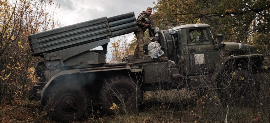 Ukrainian soldiers prepare to move their BM-21 'Grad' multiple rocket launcher after firing towards Russian positions in Kharkiv region on October 4, 2022.