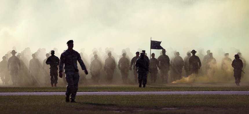 U.S. Army soldiers walk from the woods, through a cloud of smoke, for the start of a Family Day ceremony while attending basic training at Fort Jackson on September 28, 2022 in Columbia, South Carolina.