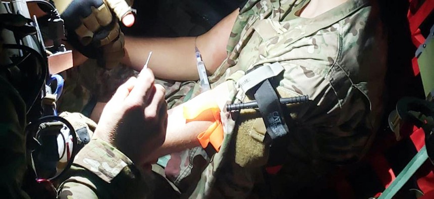 Tactical Medical Augmentation Team Airmen administer patient care to a simulated patient during a mass casualty exercise aboard an HC-130J Combat King II aircraft. 