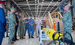 Vice Adm. Brad Cooper, commander of U.S. Naval Forces Central Command (NAVCENT), U.S. 5th Fleet and Combined Maritime Forces, center right, along with Major Gen. Ala Abdulla Seyadi, commander of the Bahrain Coast Guard, center left; and Rear Adm. Mohammed Yousif Al Asam, commander of the Royal Bahrain Naval Force, right, listen to a presentation on a Razorback unmanned underwater vehicle.