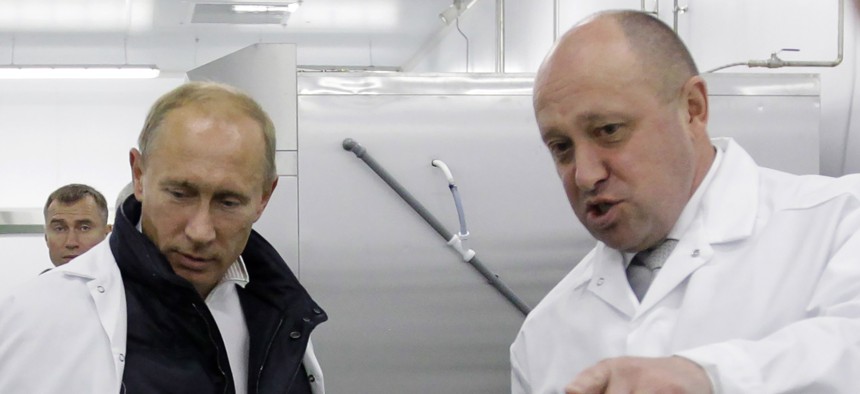Businessman Yevgeny Prigozhin shows Russian Prime Minister Vladimir Putin his school lunch factory outside Saint Petersburg on September 20, 2010. - Kremlin-linked businessman Yevgeny Prigozhin has filed a lawsuit in an EU court to remove him from the bloc's sanctions list, his company said on December 15, 2020.