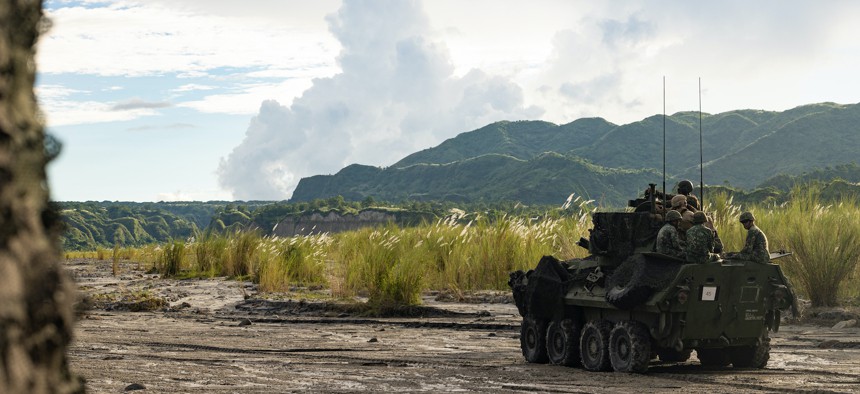 U.S. Marines with Battalion Landing Team 2d Battalion, 5th Marines, 31st Marine Expeditionary Unit and Philippine Marines with the 73rd Marine Company, Armored Assault Battalion, ride in a light armored vehicle during a reconnaissance rehearsal as part of KAMANDAG 6 at Colonel Ernesto Ravina Air Base, Tarlac, Philippines, Oct. 4, 2022. 