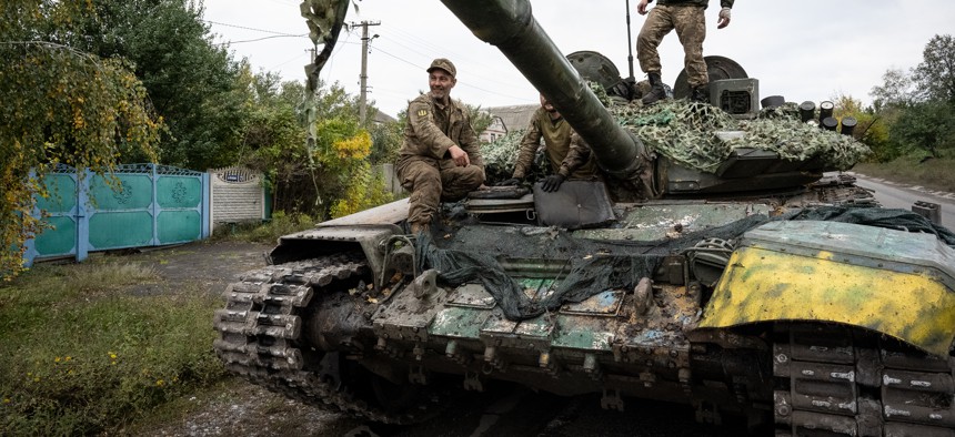 Ukrainian soldiers make adjustments to a captured Russian T-72B tank, as they drive it toward the northeastern Kharkiv region frontline on a road to Izyum, Ukraine, on September 28, 2022. 