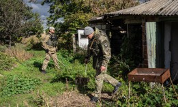 National guard special operations soldiers Alexander Lemyshka (R) and Borodai Anatoly, check for anti-personnel mines and booby traps in a compound previously used as a residence by the head of Russian occupying forces as they make it safe to be searched for evidence of war crimes by police investigators, on October 14, 2022 in Vyshneve, Kharkiv oblast, Ukraine. 