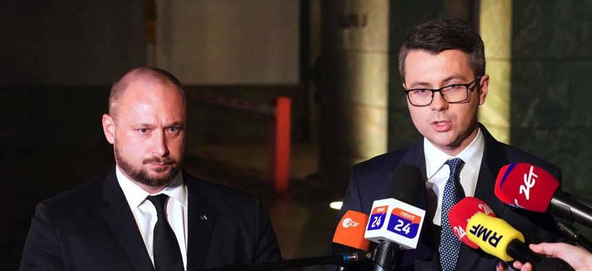 The head of Poland's Office of National Security, Jacek Siewiersk, left, and Polish government spokesman Piotr Muller speak to reporters after a crisis meeting of Siewiersk's office in Warsaw on November 15, 2022.