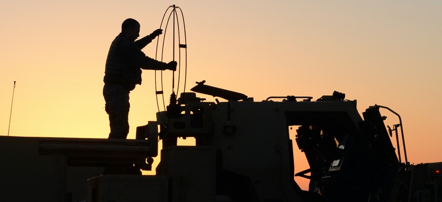 A U.S. Army soldier from 1st Battalion, 14th Field Artillery, 214th Fires Brigade, Fort Sill, Okla., unfolds an antenna on an M142 High Mobility Artillery Rocket Systems vehicle during a radio check, March 6, 2015.