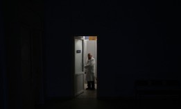 A hospital employee stands at the doorstep of a maternity ward during a blackout after Russian attacks in the Western Ukrainian city of Lviv on November 23, 2022, amid the Russian invasion of Ukraine