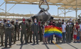 Airmen and family members pose on the flight line at Luke Air Force Base, Ariz., after a Pride Month flyby on June 26, 2020.