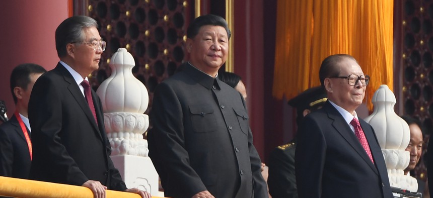 Chinese President Xi Jinping (C) attends a military parade with former presidents Hu Jintao (L) and Jiang Zemin in Tiananmen Square in Beijing on October 1, 2019