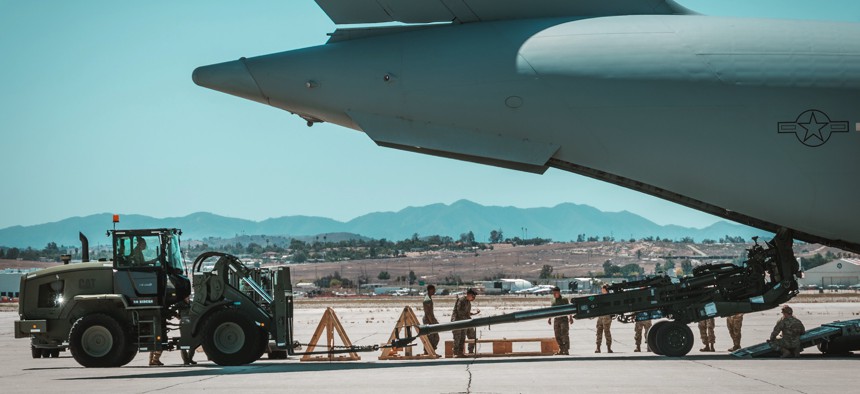 A U.S. Marine Corps M777 towed 155 mm howitzer is loaded into the back of a U.S. Air Force C-17 Globemaster III aircraft at March Air Reserve Base, California, April 23, 2022.