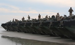 Marines with the 2nd Assault Amphibian Battalion wait for the final check of their amphibious assault vehicles during a 2015 exercise at Camp Lejeune N.C.
