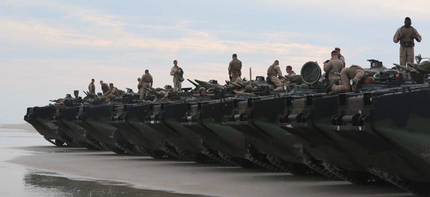 Marines with the 2nd Assault Amphibian Battalion wait for the final check of their amphibious assault vehicles during a 2015 exercise at Camp Lejeune N.C.