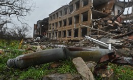 A Russian Grad rocket rests by a war-damaged school in Posad-Pokrovske, in Ukraine's Kherson region, on December 11, 2022. 
