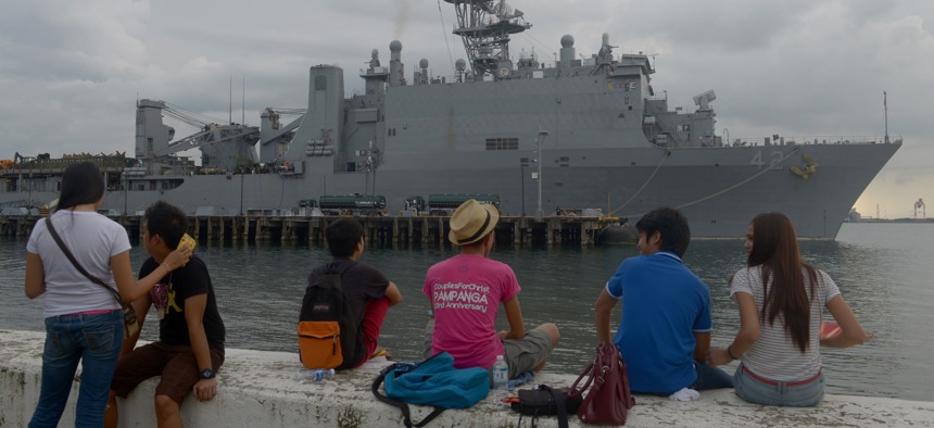 In this file photo, students watch the dock landing ship Germantown in the northern Philippine port city of Olongapo.