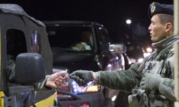 A patrolman with the 2nd Security Forces Squadron at Barksdale Air Force Base, La., hands an identification card back to an Airman as they enter the gate.