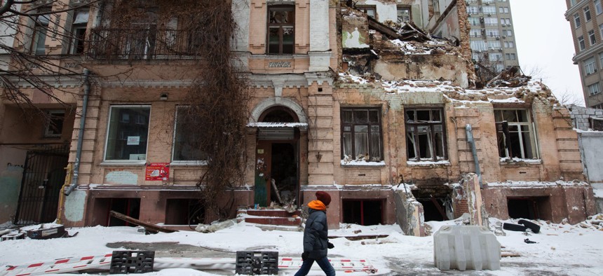 A man walks past a residential building destroyed by a Russian drone in Kyiv, Ukraine on January 12, 2023.