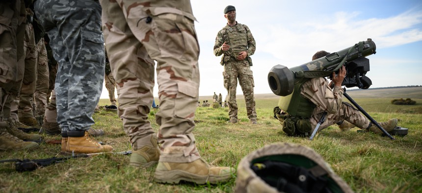 A Ukrainian recruit looks through the viewfinder of a Raytheon Technologies FGM-148 Javelin surface-to-air missile while training with UK armed forces in southern England on October 11, 2022. 