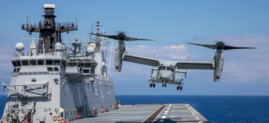A U.S. Marine Corps MV-22B Osprey performs deck landing maneuverers aboard Royal Australian Navy landing helicopter dock HMAS Canberra (L02) during Rim of the Pacific (RIMPAC) 2022.