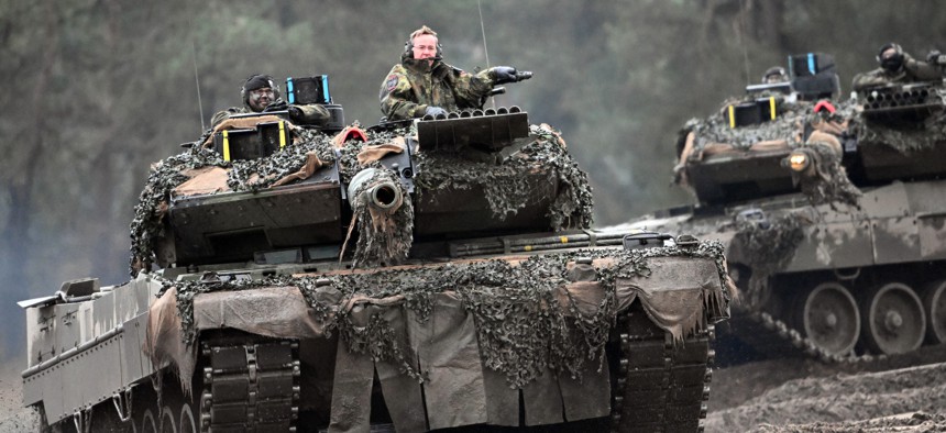 German Minister of Defense Boris Pistorius rides in the turret of a Leopard 2A6 with a soldier from the German Army's Tank Battalion 203 on Feb. 1, 2023.