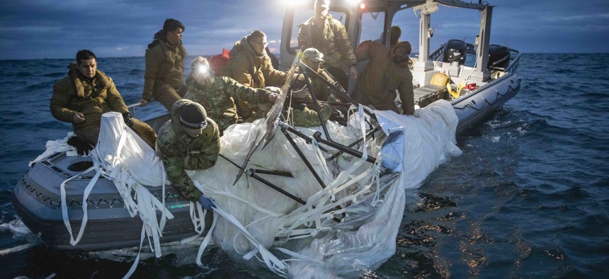 Sailors assigned to Explosive Ordnance Disposal Group 2 recover a high-altitude surveillance balloon off the coast of Myrtle Beach, South Carolina, Feb. 5, 2023